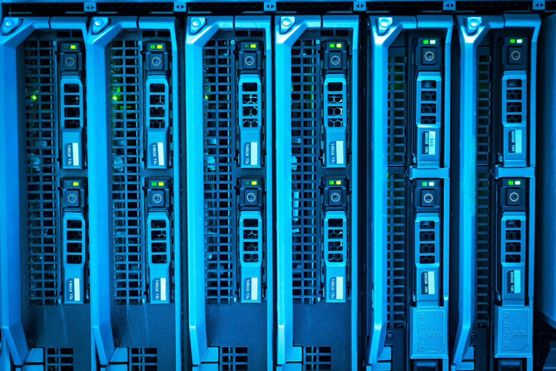 A single illuminated server unit glowing blue in an otherwise dark rack, evoking a system deliberately kept independent from the environment it protects.